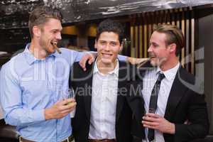 Handsome friends having a drink together