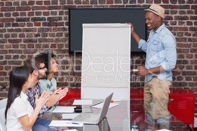 Casual businessman giving presentation to colleagues