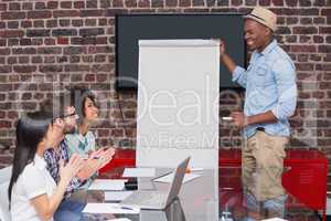 Casual businessman giving presentation to colleagues