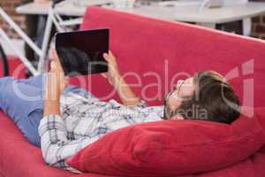 Casual man using digital tablet on couch