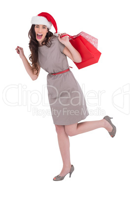 Festive brunette in dress holding shopping bags