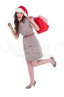 Festive brunette in dress holding shopping bags