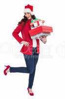 Excited brunette in red coat holding many gifts