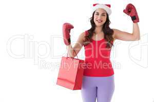 Festive brunette in boxing gloves with shopping bag