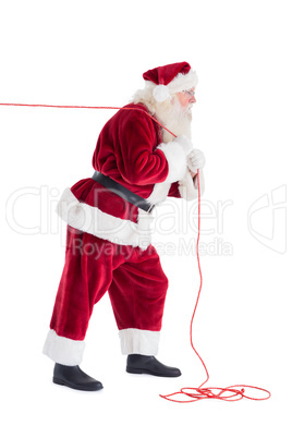 Santa pulls something with a rope