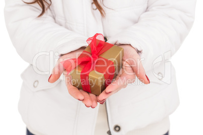 Woman in white coat holding gift