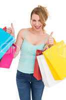 Woman holding shopping bags with the thumbs up