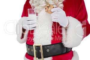 Santa holding cookie and glass of milk