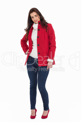 Beauty brunette posing in red coat and heels