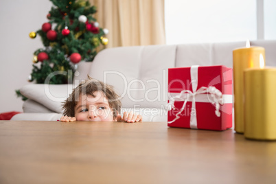 Festive little boy looking at gifts