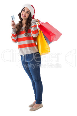 Happy brunette holding shopping bags and credit card