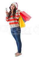 Happy brunette holding shopping bags and credit card