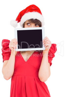 Festive brunette holding a tablet pc