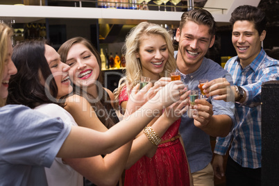 Happy friends having a drink together