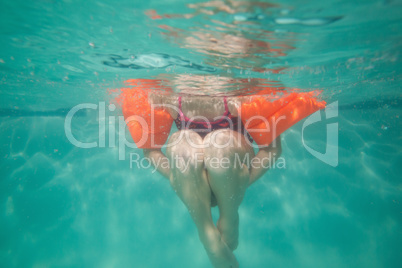 Cute kid posing underwater in pool