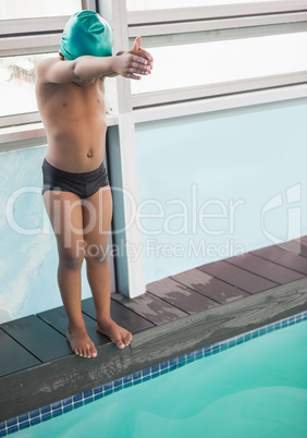 Cute little boy ready to dive in the pool