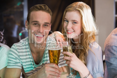 Happy friends having a drink together