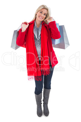 Blonde in winter clothes holding shopping bags