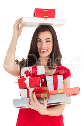 Smiling brunette holding many gifts