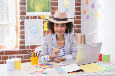 Smiling female interior designer at desk