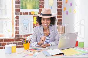 Smiling female interior designer at desk