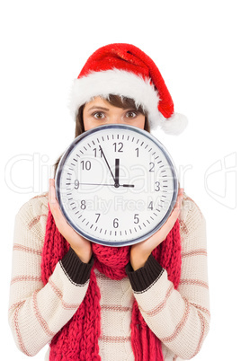 Festive brunette holding a clock