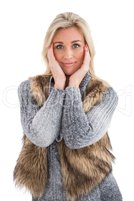 Blonde in winter clothes smiling at camera