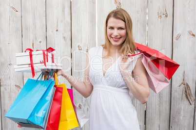 Elegant blonde with shopping bags and gifts