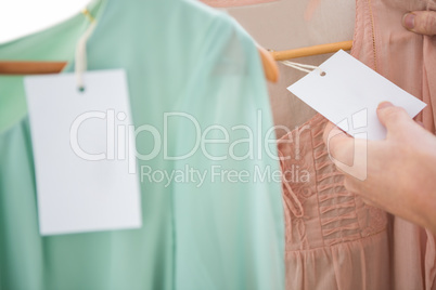 Woman holding price tag on shirt