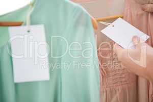 Woman holding price tag on shirt