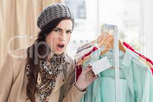 Pretty brunette shocked at price of shirt