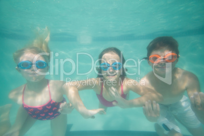 Cute kids posing underwater in pool