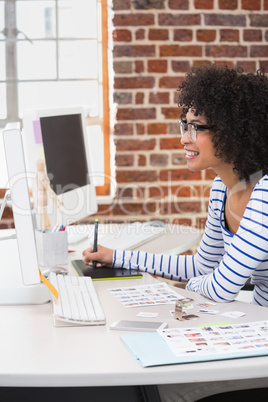 Female photo editor using digitizer in office