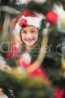 Festive litte girl decorating christmas tree