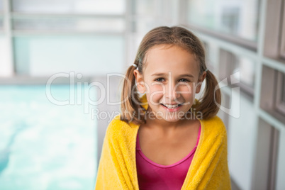 Cute little girl sitting poolside