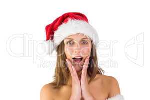 Pretty santa girl with hands on face