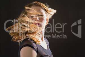 Pretty blonde woman tossing hair