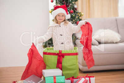 Cute little girl sitting in giant christmas gift