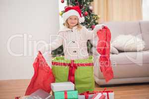 Cute little girl sitting in giant christmas gift