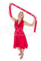 Stylish blonde in red dress holding scarf