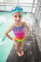 Cute little girl standing poolside