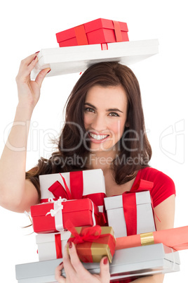 Smiling brunette holding many gifts