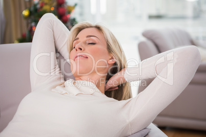 Blonde relaxing on the couch at christmas