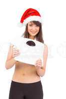 Festive fit brunette holding a weighing scales