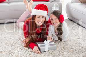 Festive mother and daughter smiling at camera