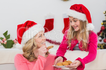 Festive mother and daughter with plate of cookies