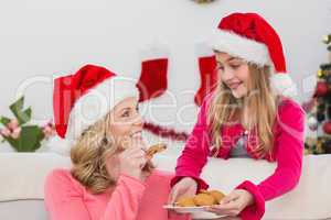 Festive mother and daughter with plate of cookies