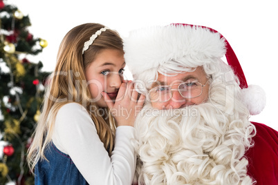 Little girl teling santa claus a secret