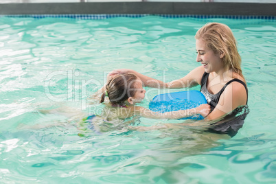 Happy mother and daughter in the swimming pool