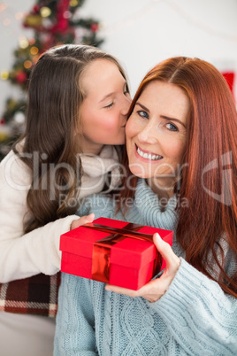 Daughter giving her mother a christmas present